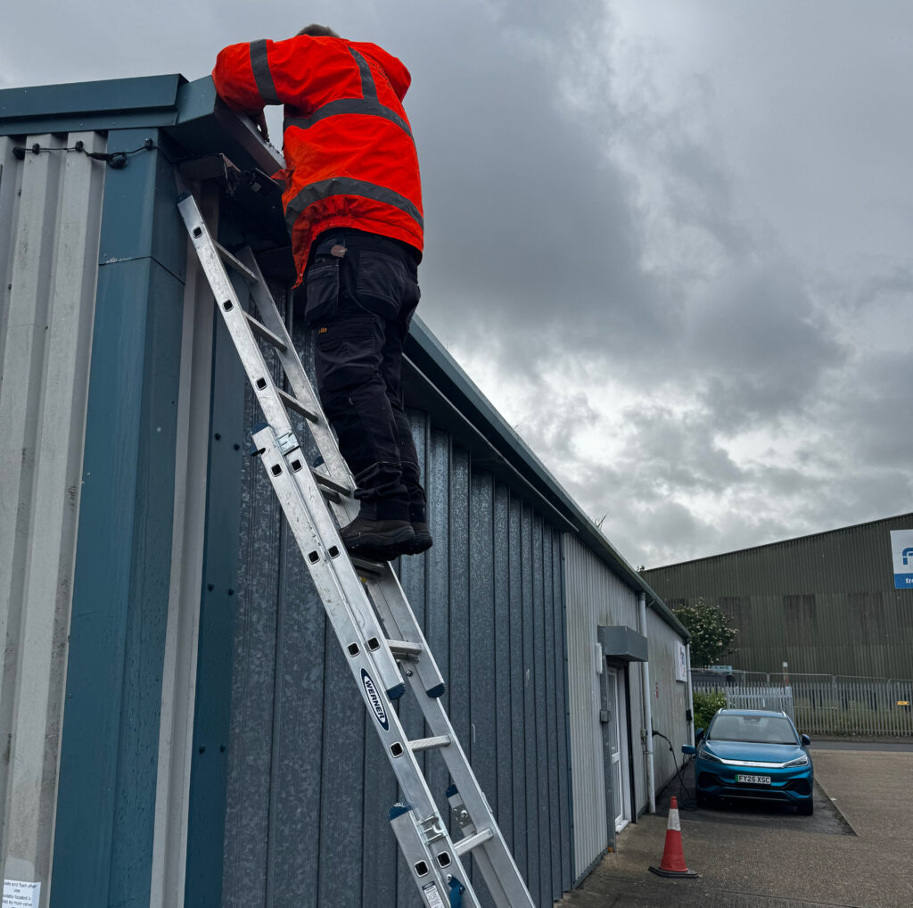 AC Guttering engineer working on a commercial unit's gutters
